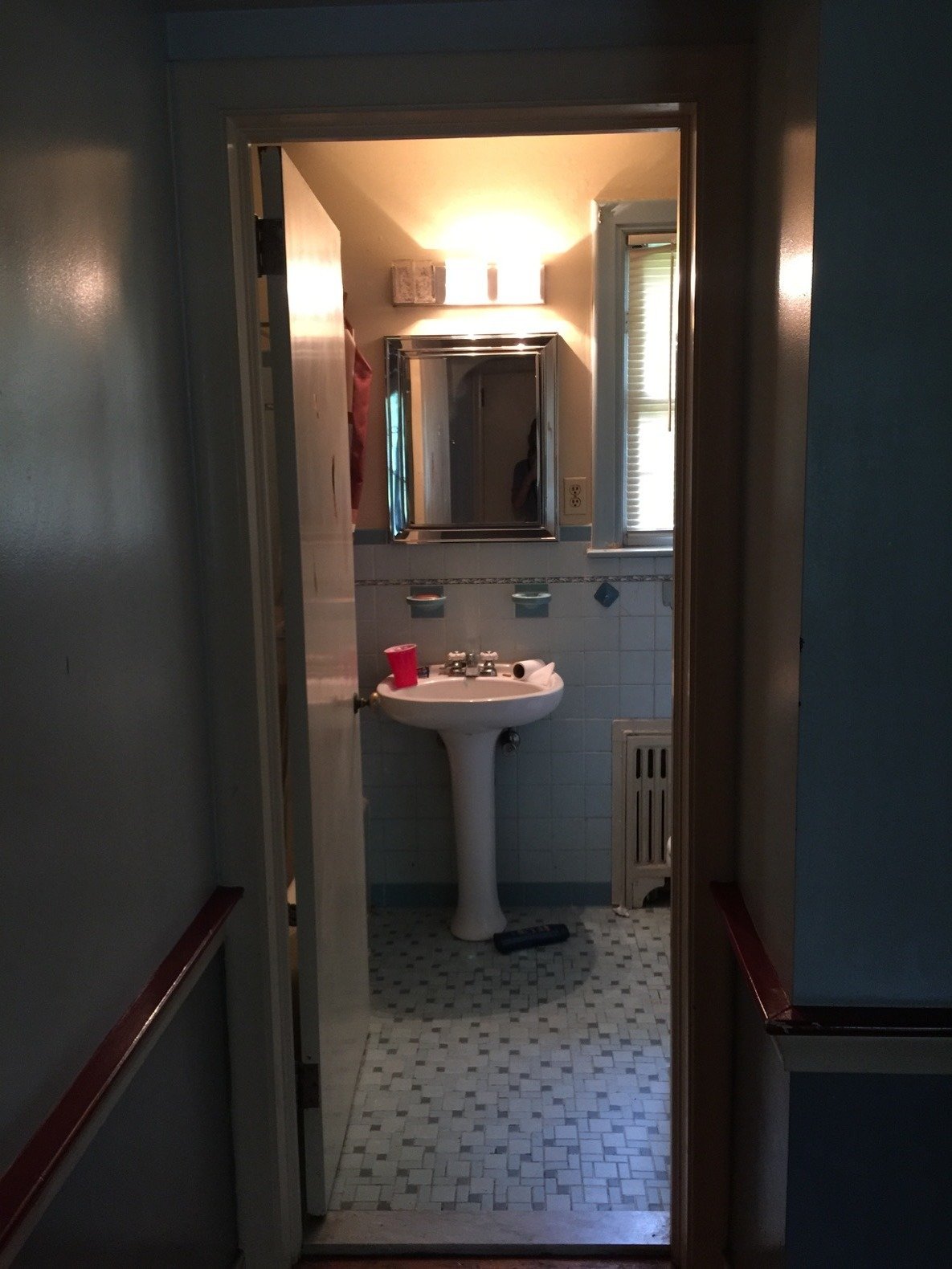 The hallway bathroom couldn't be salvaged, and the original tile was discarded. 